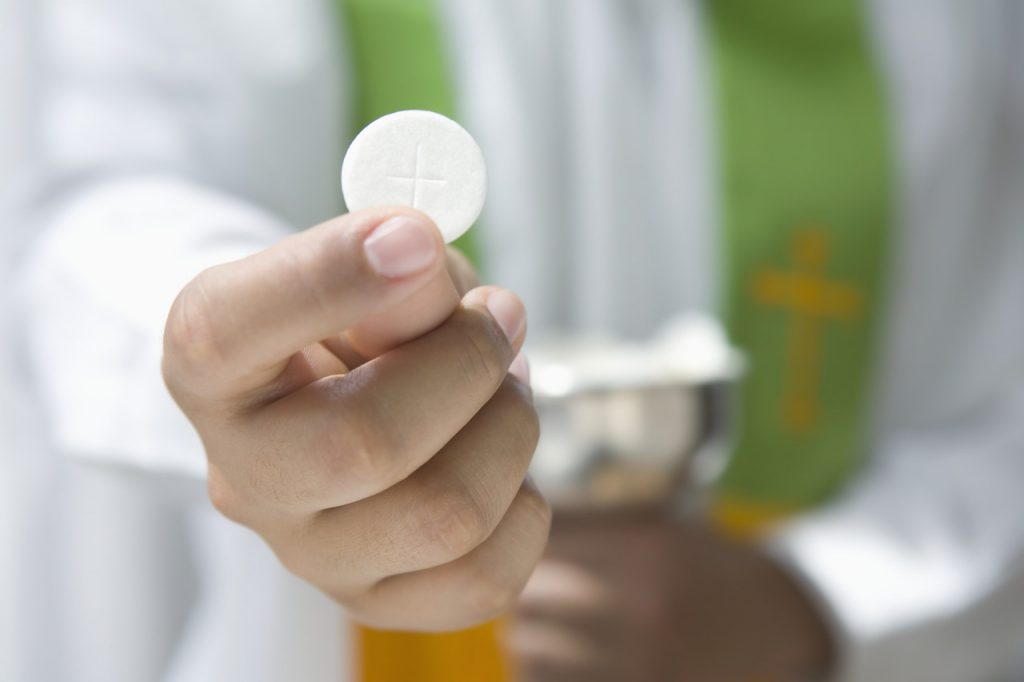 Priest Holding Communion Wafer